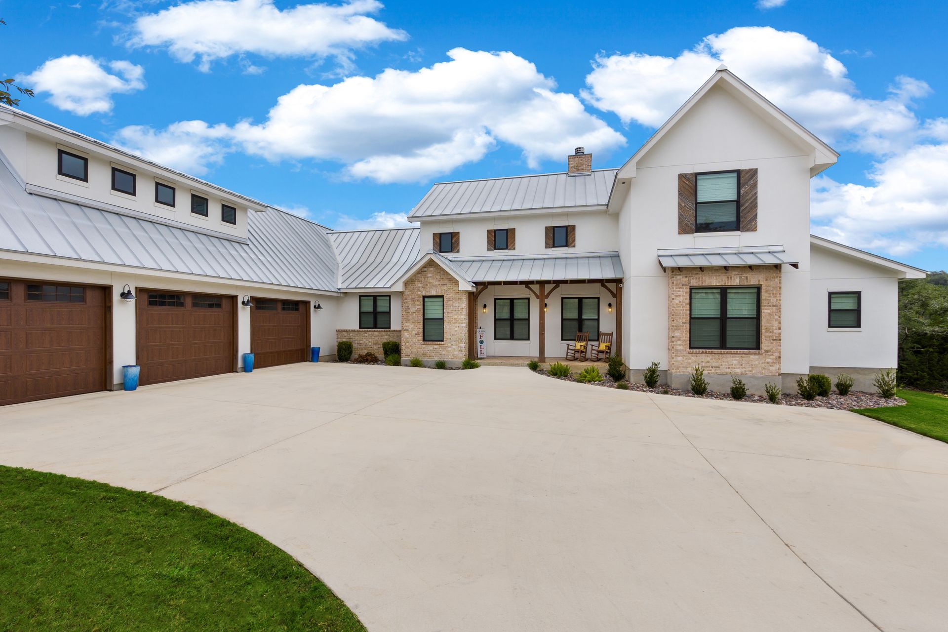 A modern farmhouse with a white exterior.