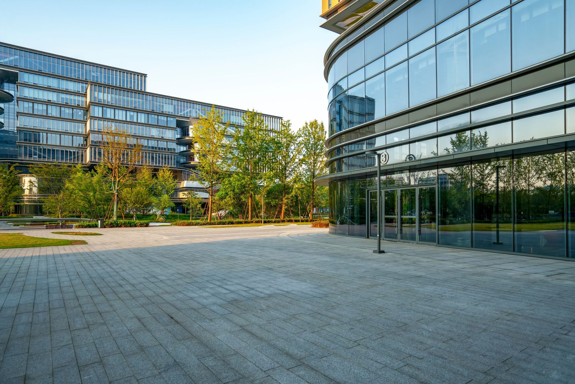 A modern office plaza with paved ground.