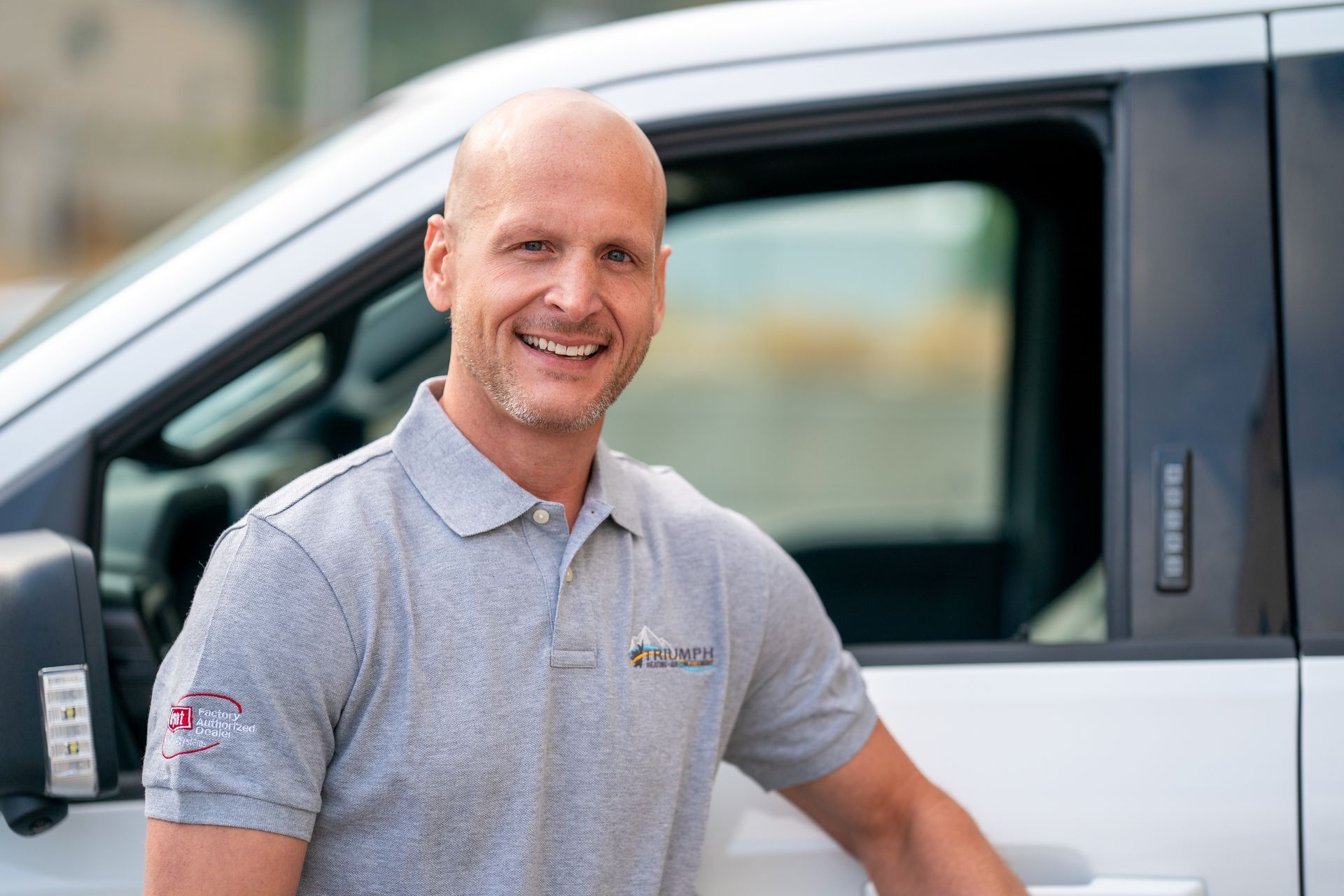 A woman wearing glasses and a red shirt is smiling for the camera.