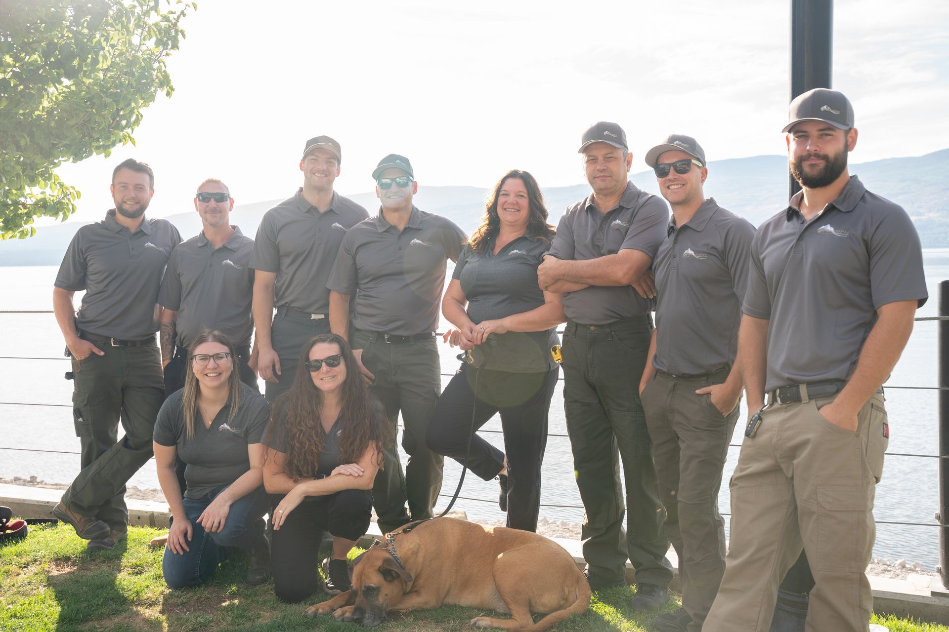 A group of people are posing for a picture in front of a large red silo.