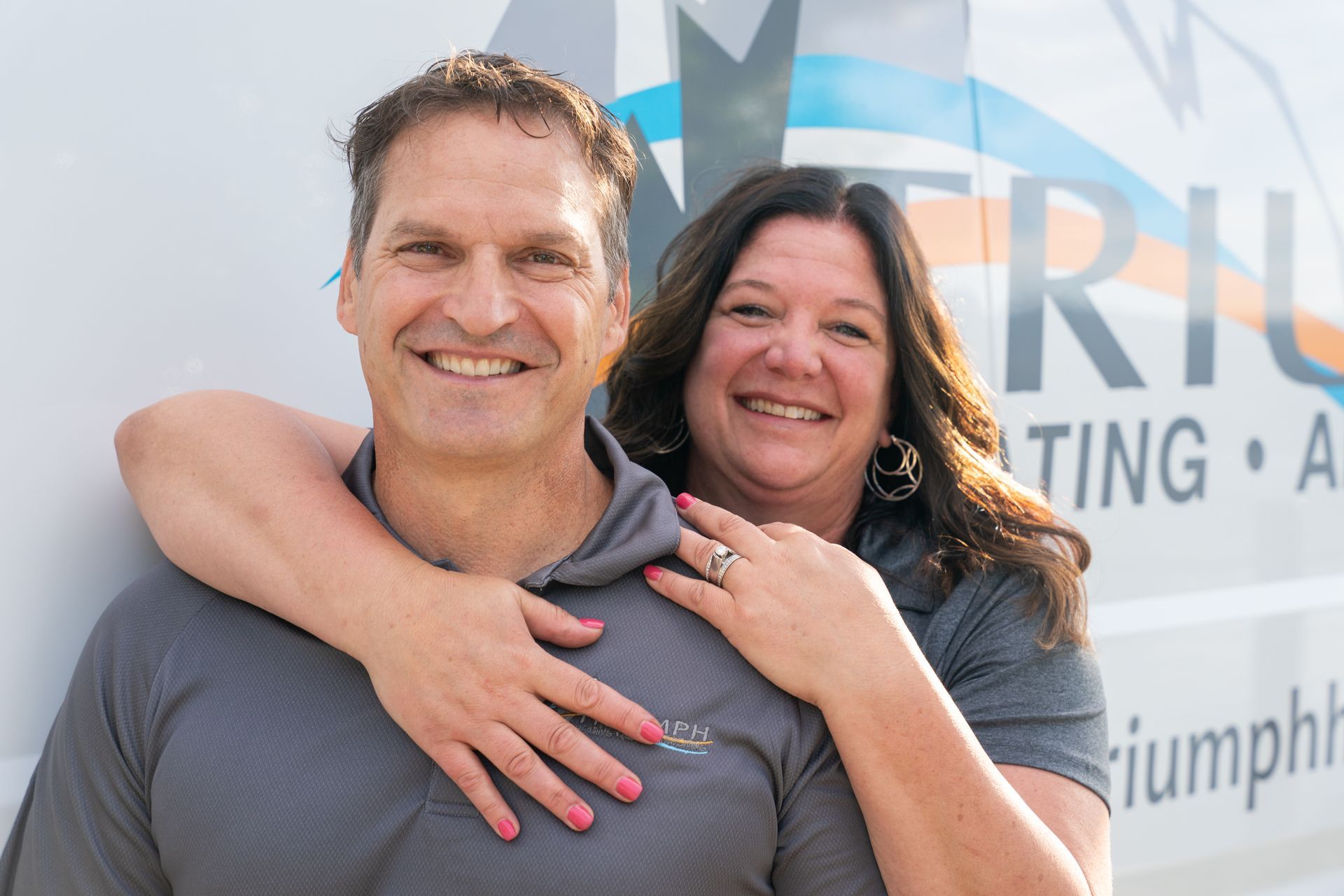 Triumph team standing in front of a triumph van