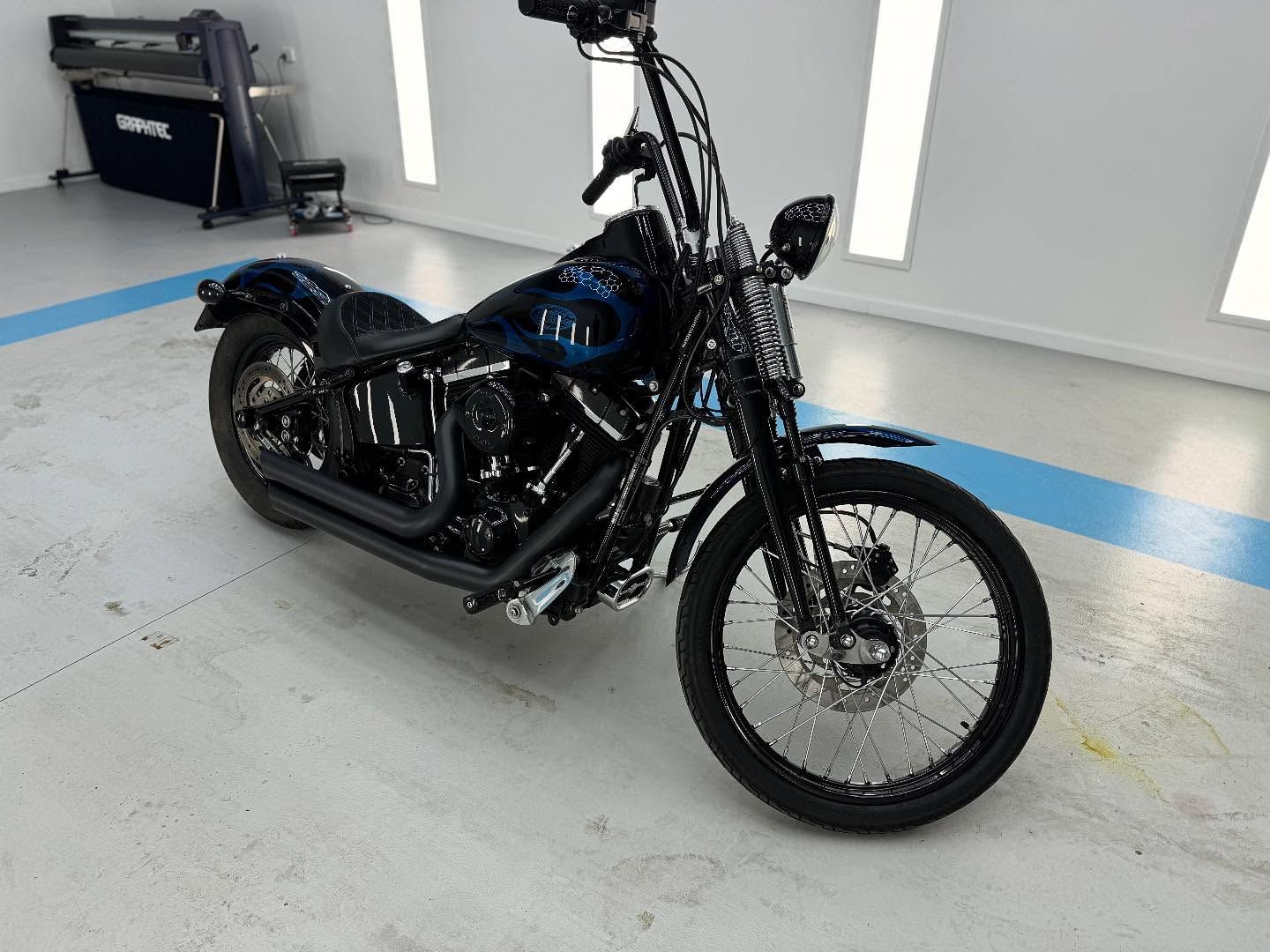 A Black Harley Davidson Motorcycle is Parked in a Garage — Bathurst Detailing Studio in Forbes, NSW