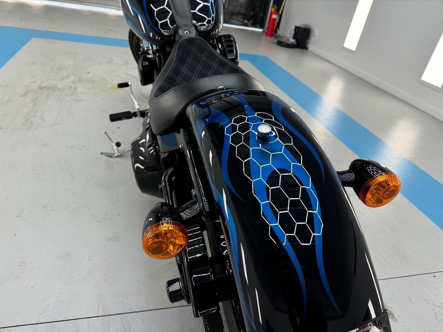 A Black and Blue Motorcycle is Parked in a Garage — Bathurst Detailing Studio in Forbes, NSW