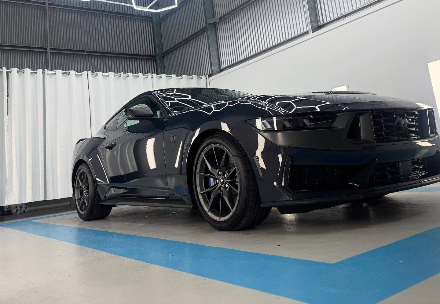 A Black Ford Mustang is Parked in a Garage — Bathurst Detailing Studio in Mudgee, NSW