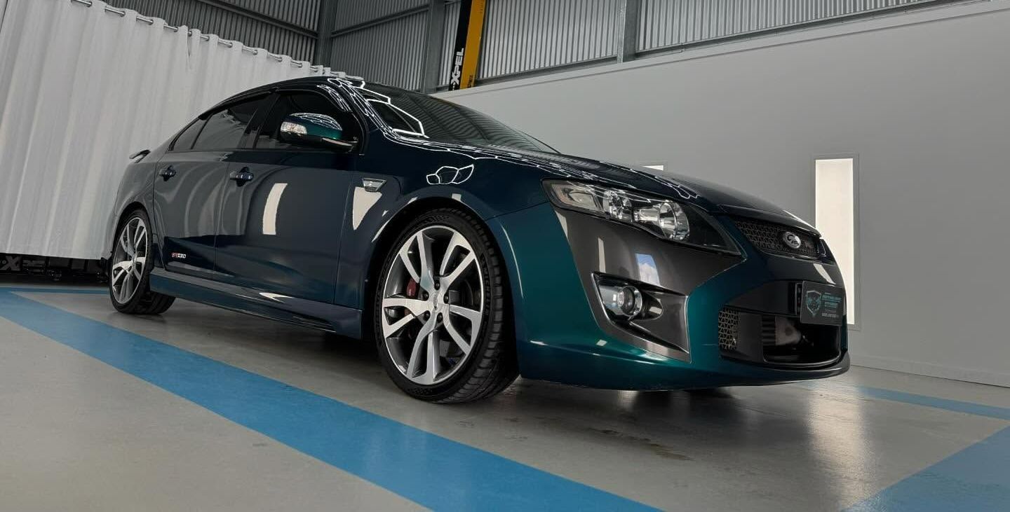 A Blue Car is Parked in a Garage Next to a White Wall — Bathurst Detailing Studio in Dubbo, NSW