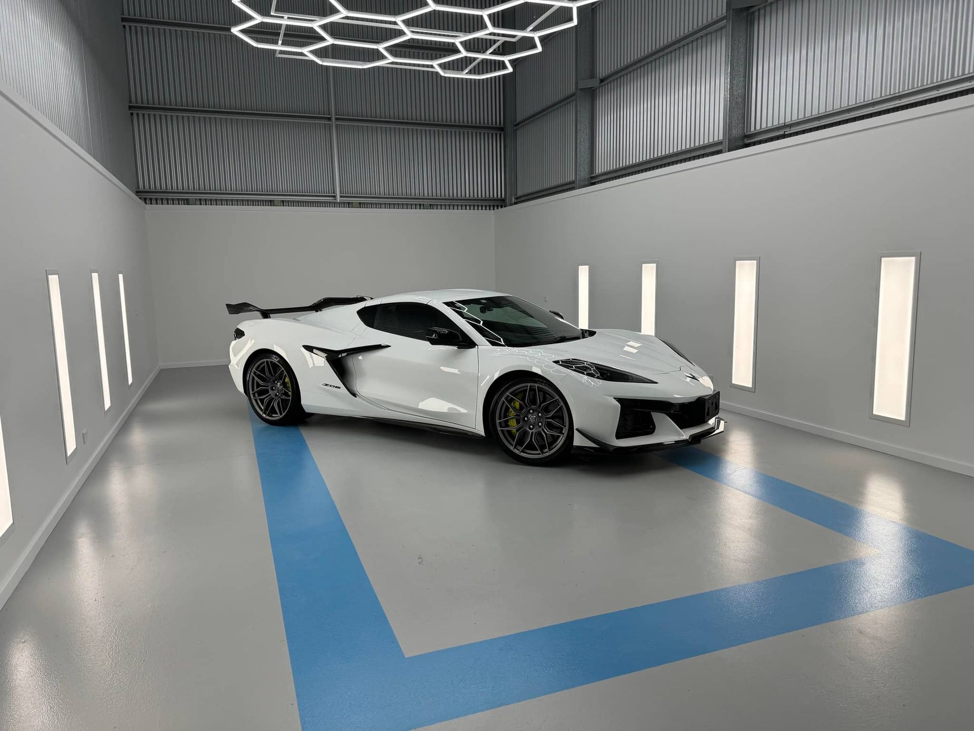 A White Corvette is Parked in a Garage — Bathurst Detailing Studio in Bathurst, NSW
