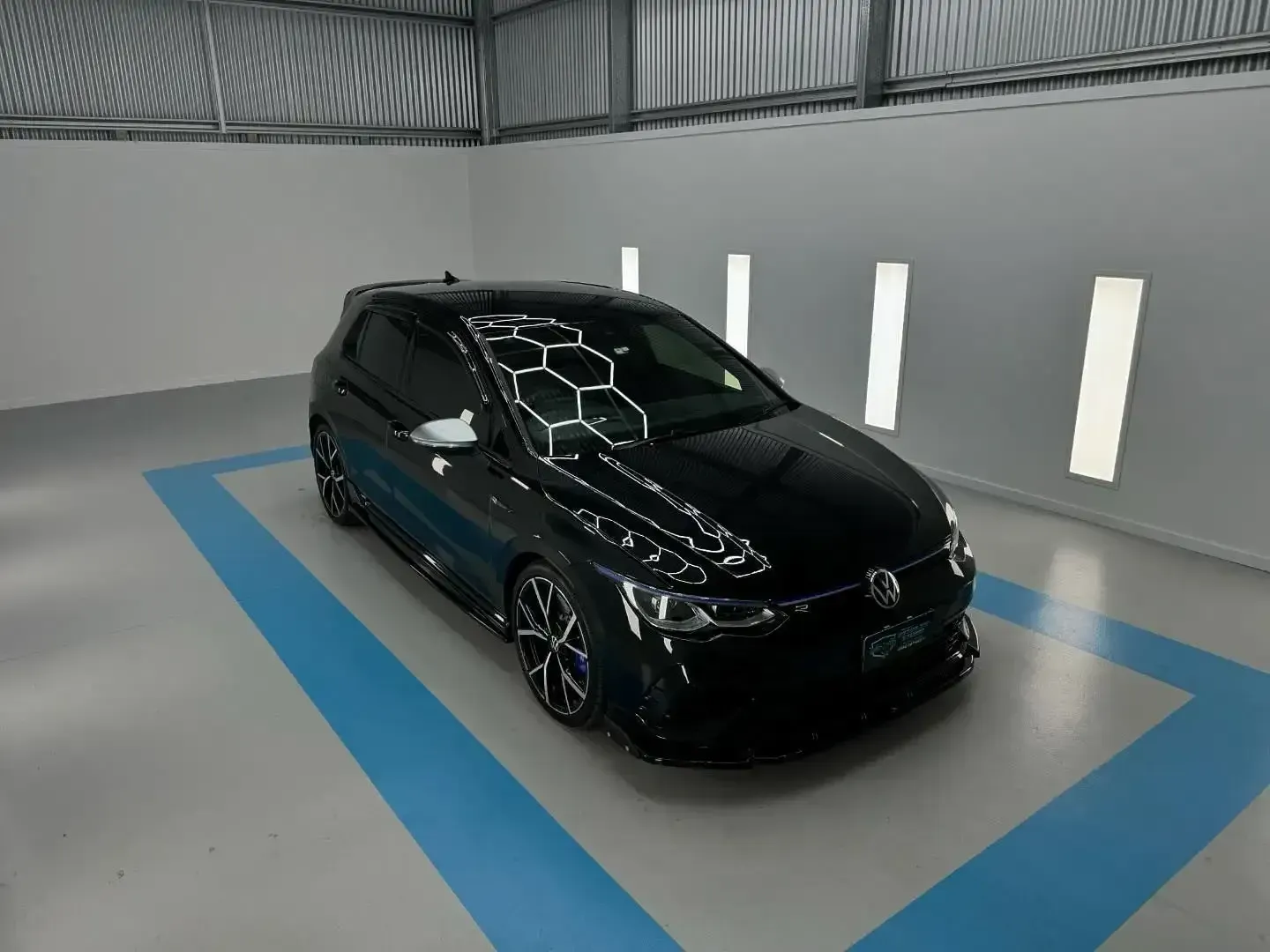 A Black Volkswagen Golf is Parked in a Garage — Bathurst Detailing Studio in Bathurst, NSW
