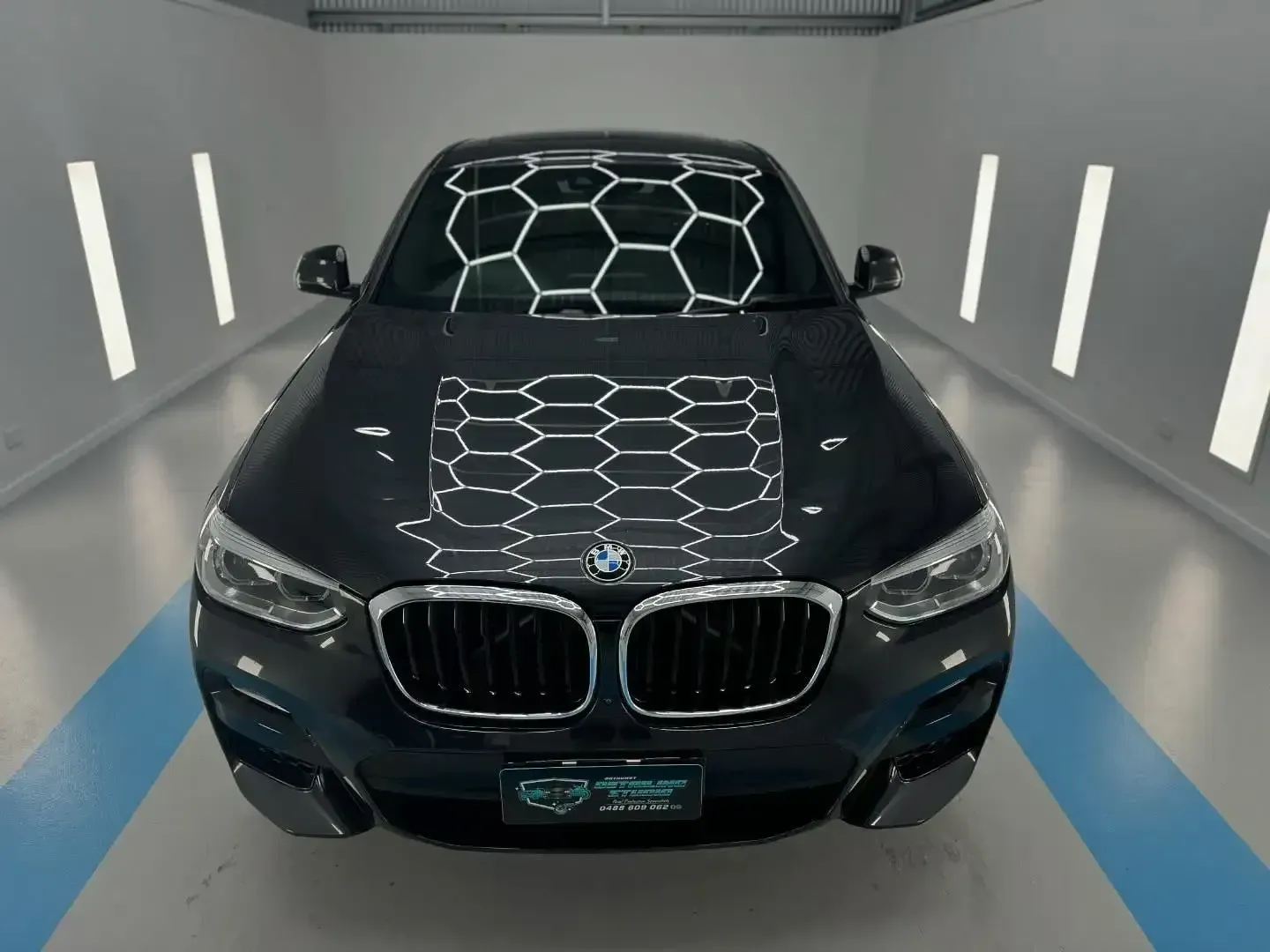 A Black BMW is Parked in a Garage — Bathurst Detailing Studio in Bathurst, NSW