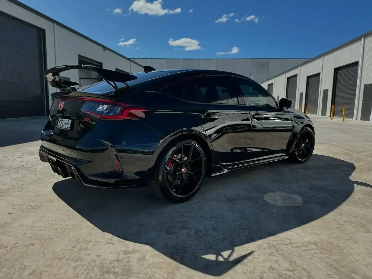 A Black Car is Parked in a Parking Lot in Front of a Building — Bathurst Detailing Studio in Bathurst, NSW