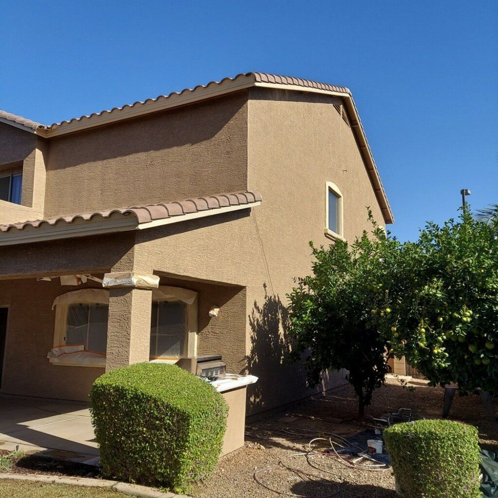 A brown house with a blue sky in the background