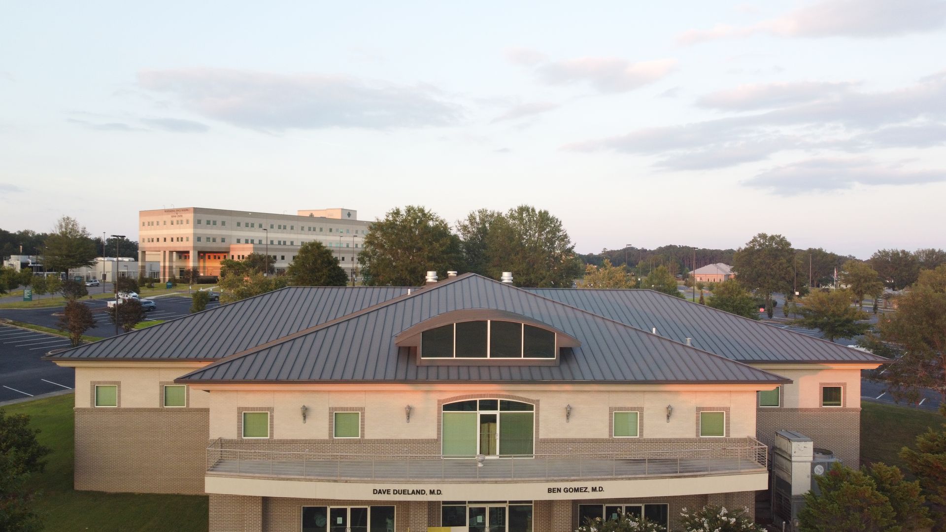An aerial view of a large building with a metal roof