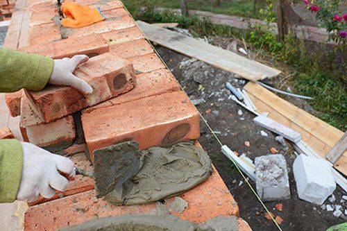 Laying mud to install bricks