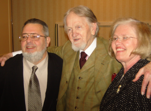 Two men and a woman pose for a picture together