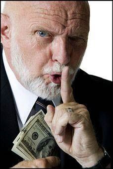 A man with a beard is holding a stack of money in his hand.