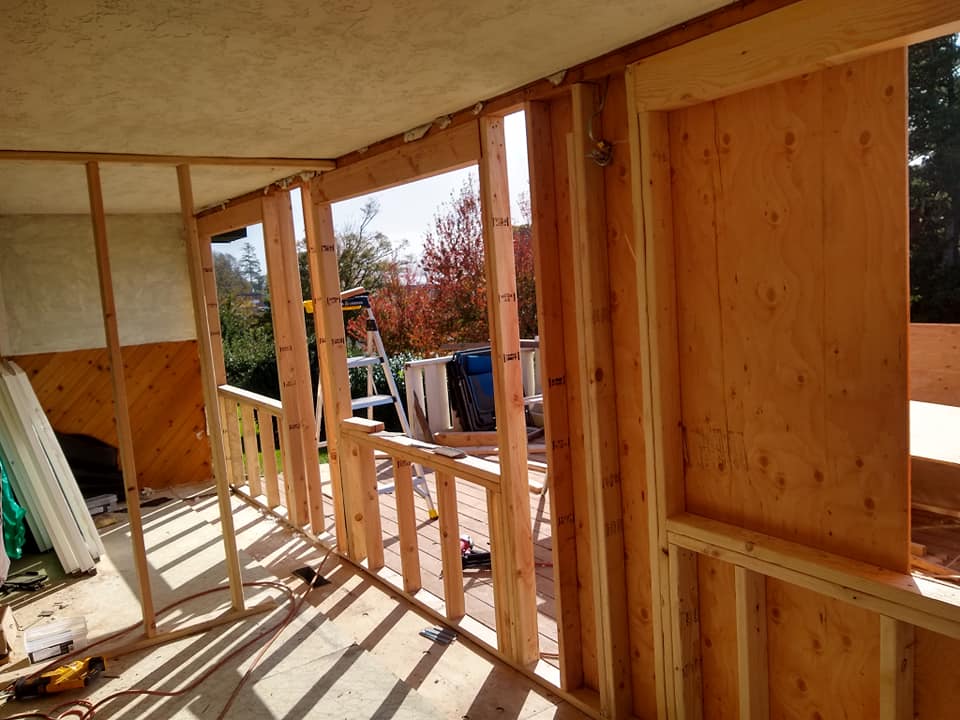 A room with wooden walls and a window being built