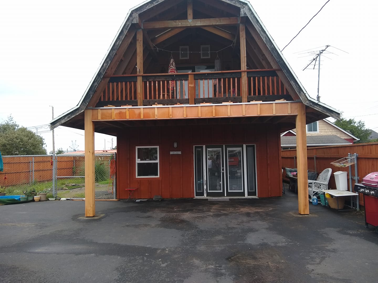 A red house with a balcony on top of it