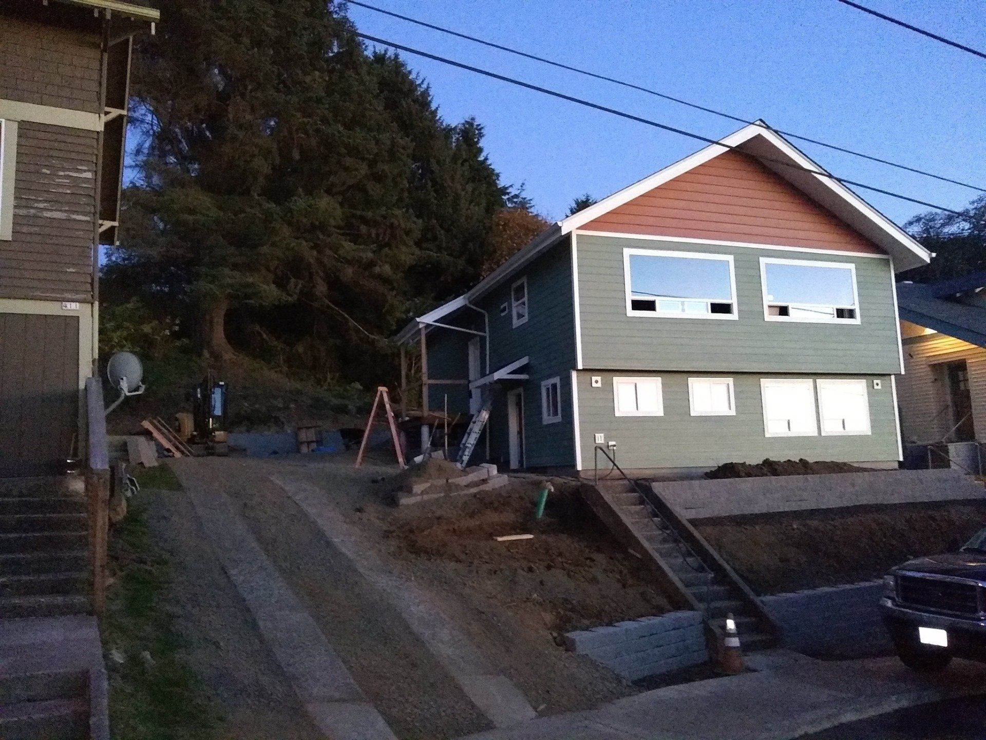 A house with a lot of windows is on a hill
