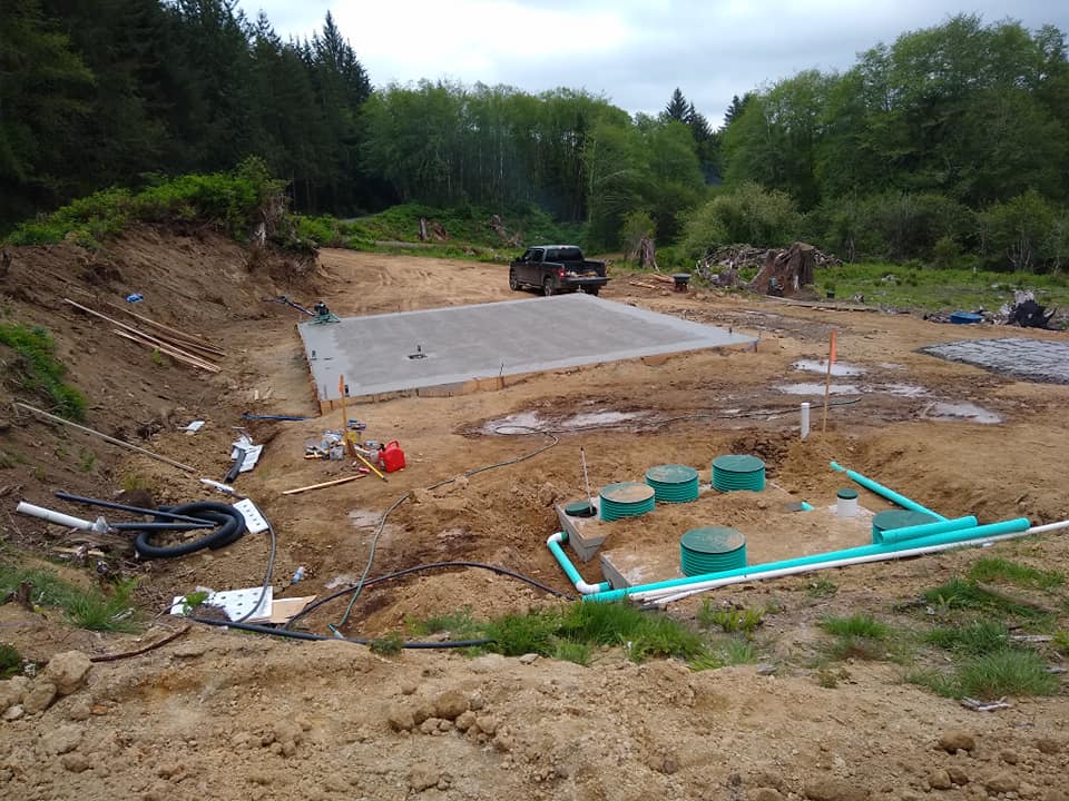 A truck is parked in the middle of a dirt field.