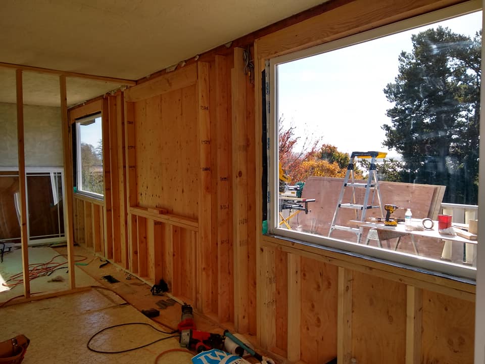 A room with wooden walls and a large window.