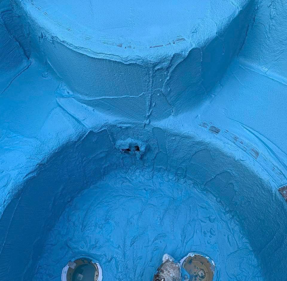 Blue, rounded, indoor structure with some cracks and holes.