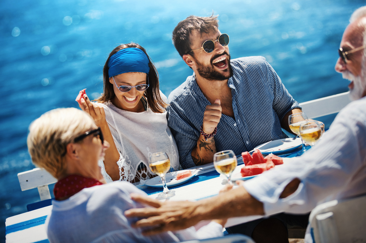 Family of three smiling and enjoying a boat ride on a sunny day at sea.