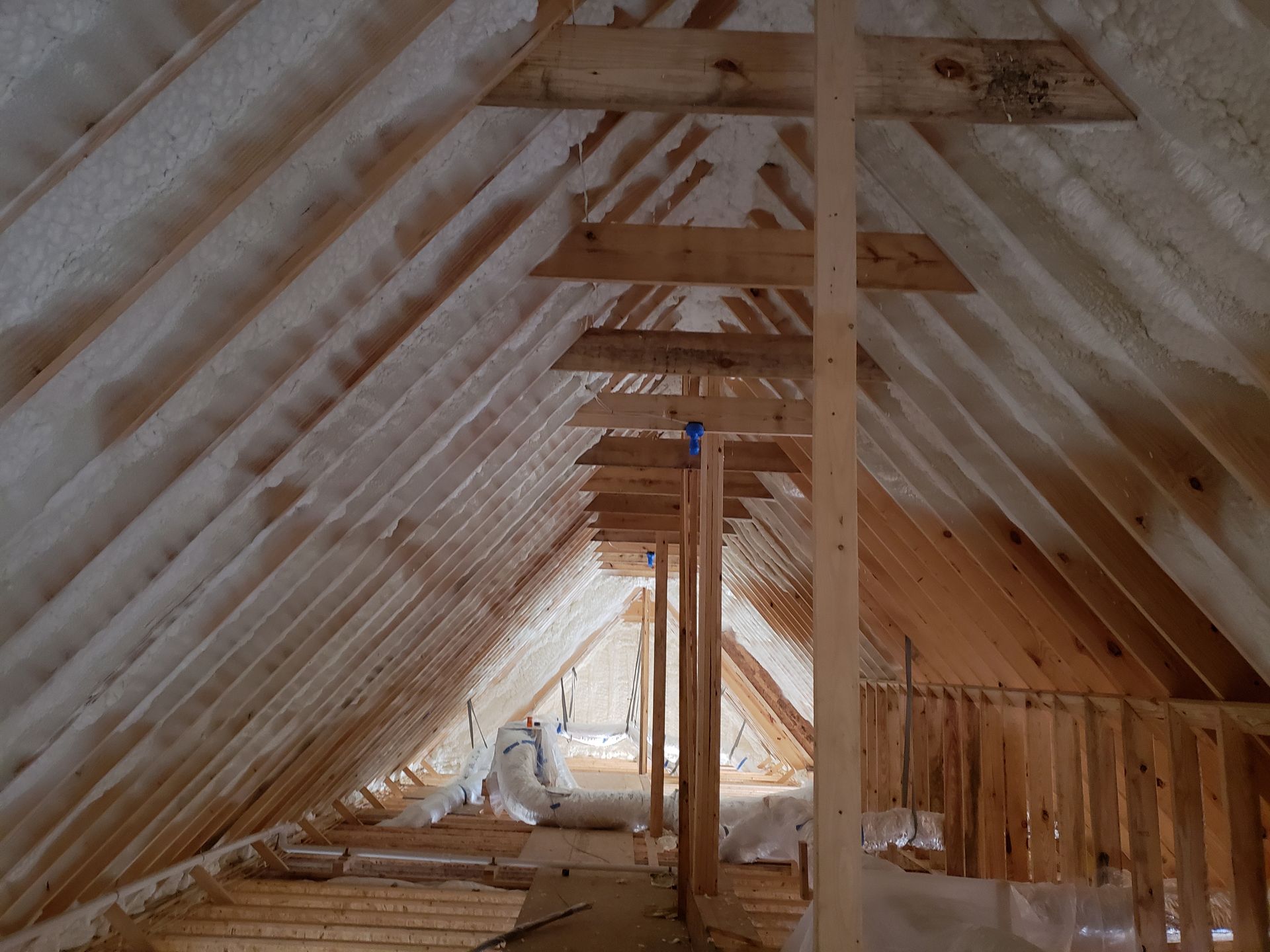 An attic with a lot of foam on the ceiling