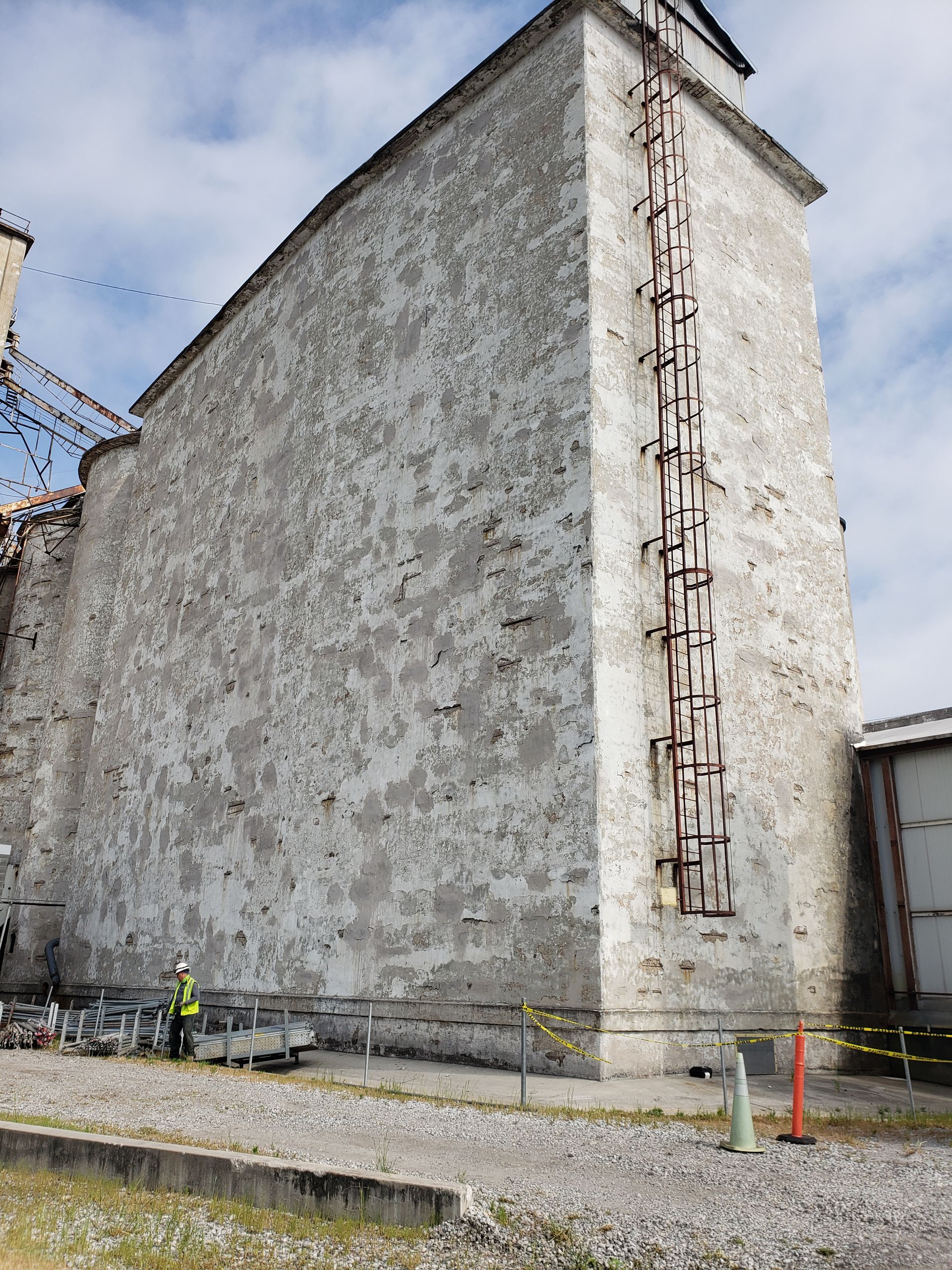 A large stone building with a ladder on the side of it.