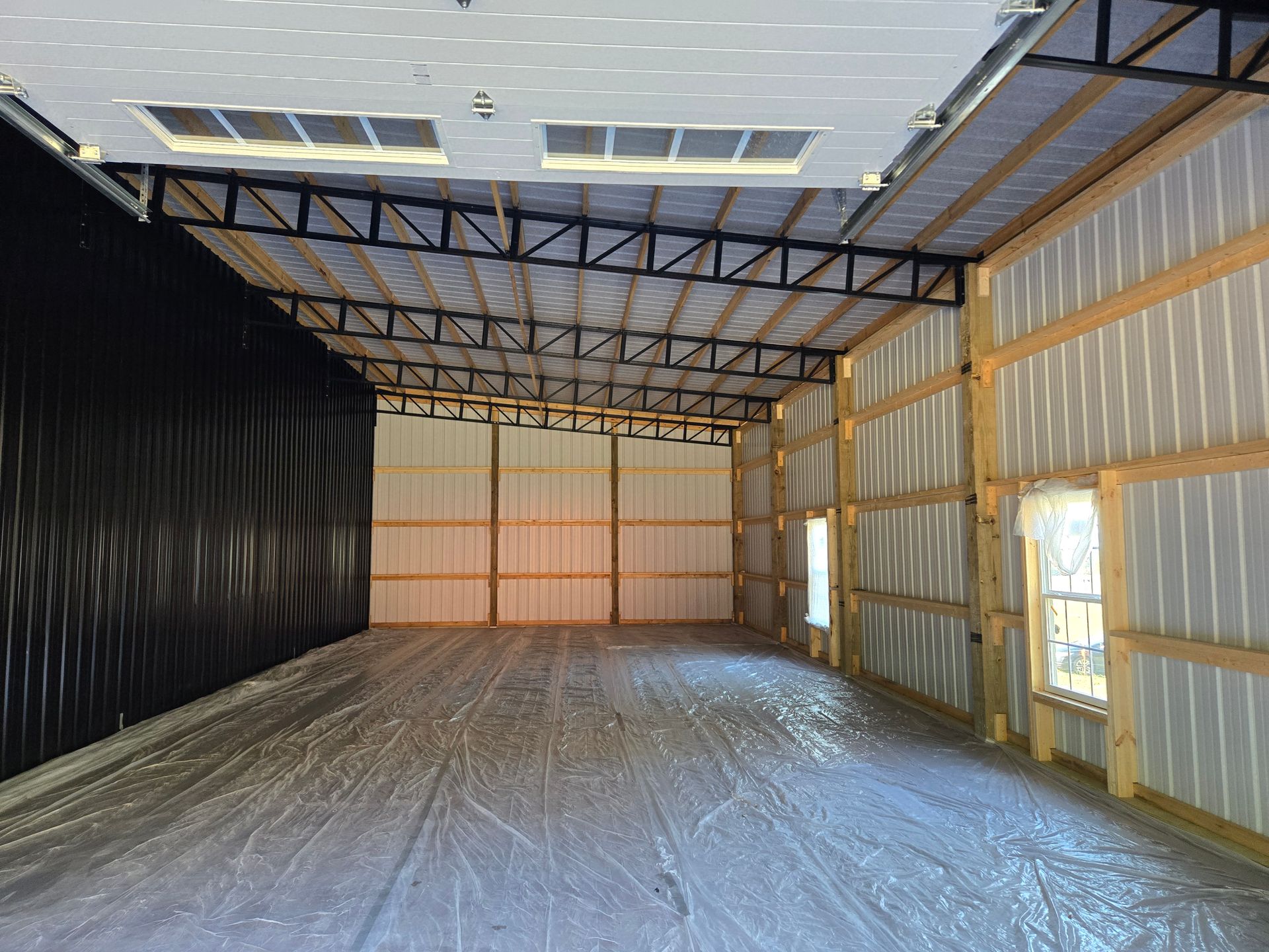 A large empty building with a large garage door.