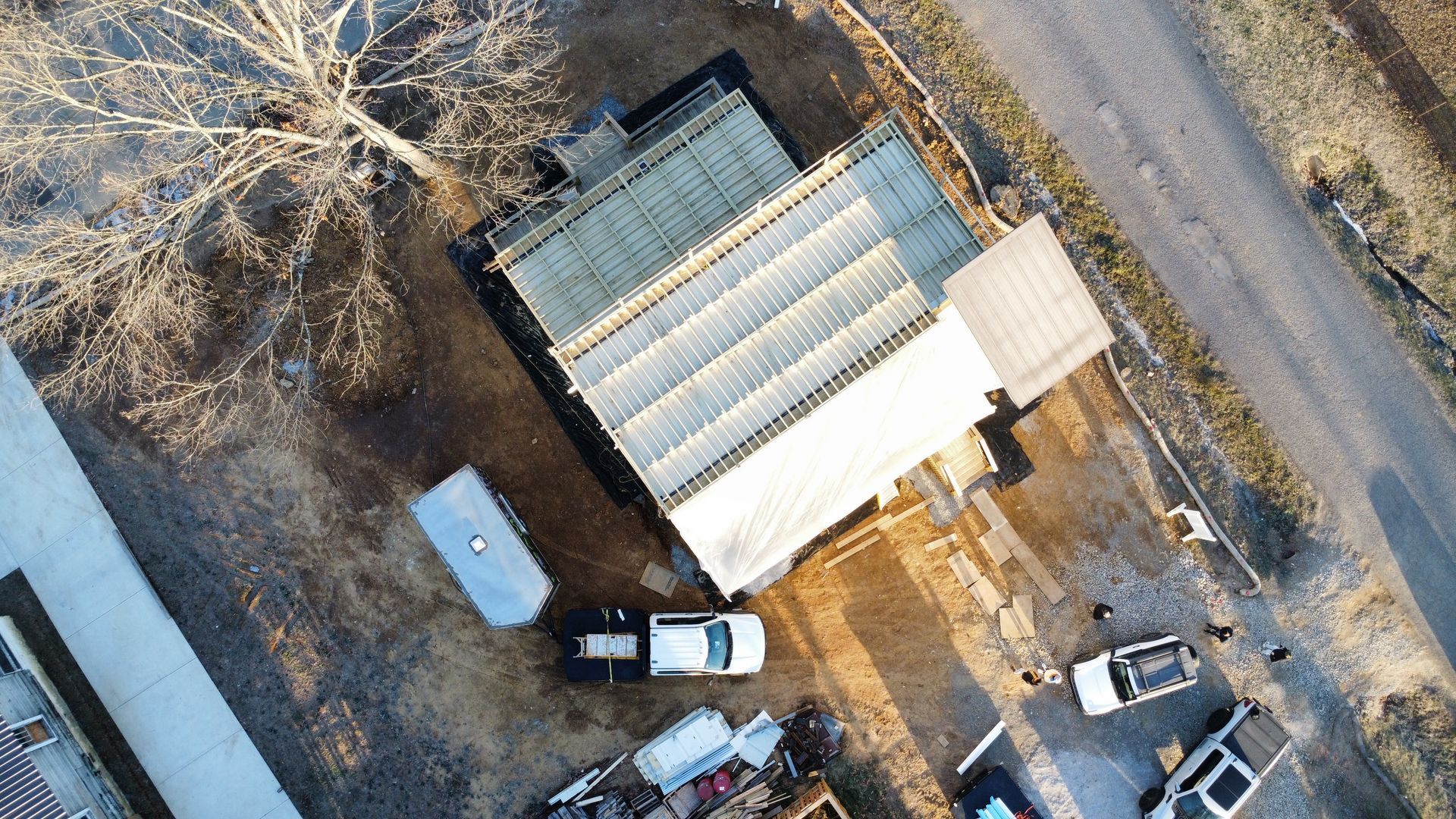 An aerial view of a house with a lot of solar panels on the roof.