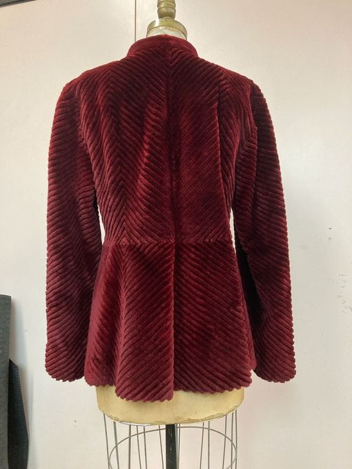 The back of a maroon fur coat on a mannequin