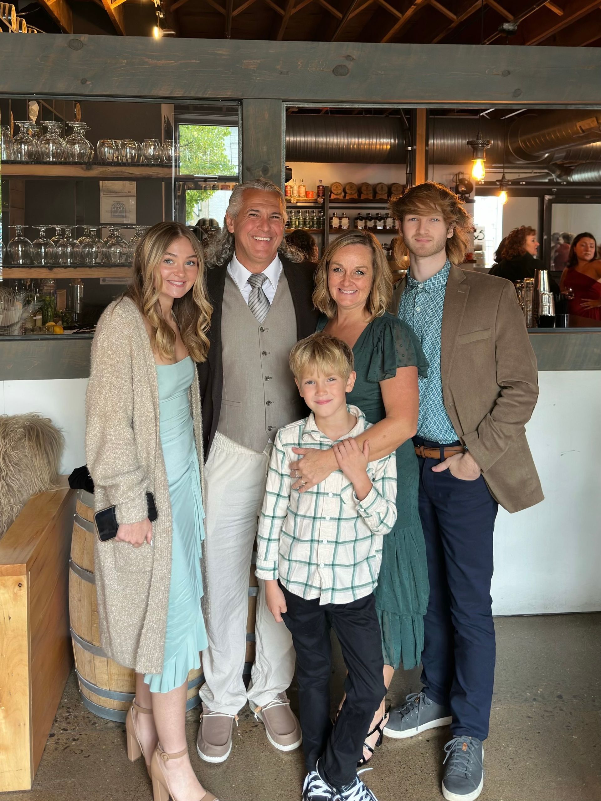 A family is posing for a picture in a restaurant.