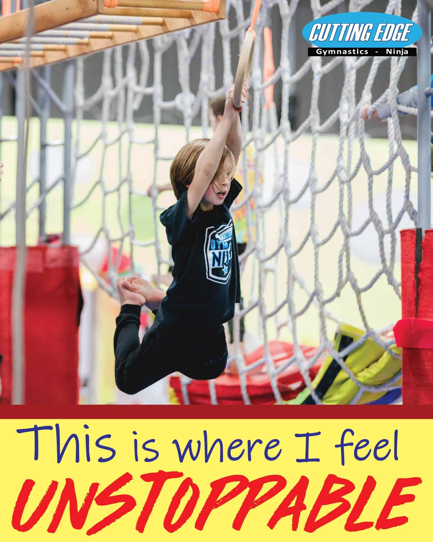 A young boy is jumping over a ropes course.