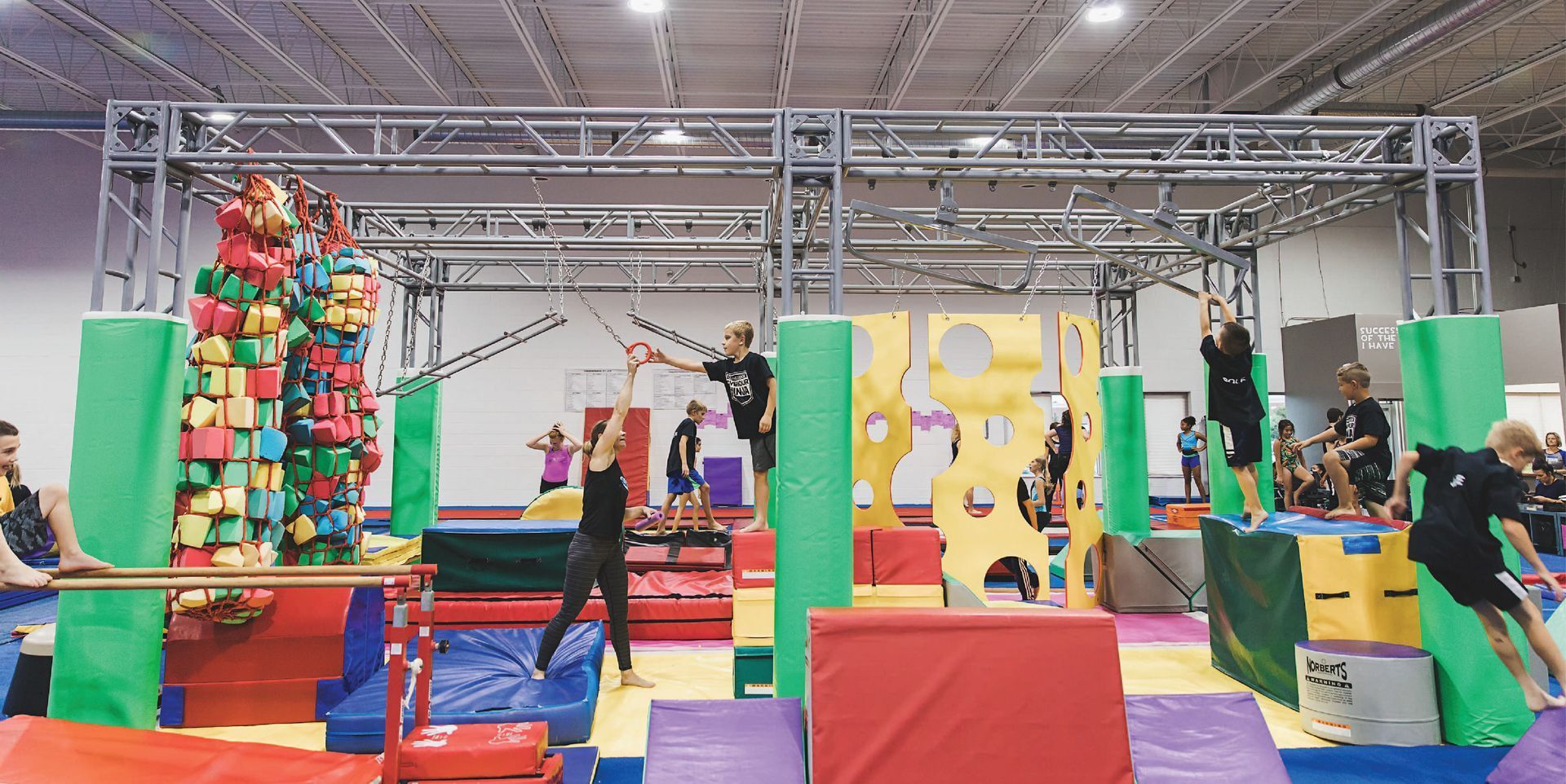 A group of people are playing in a gym.