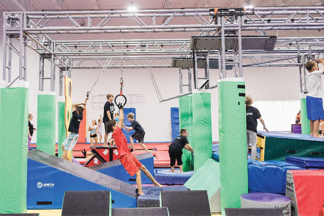 A group of people are playing in a gym.