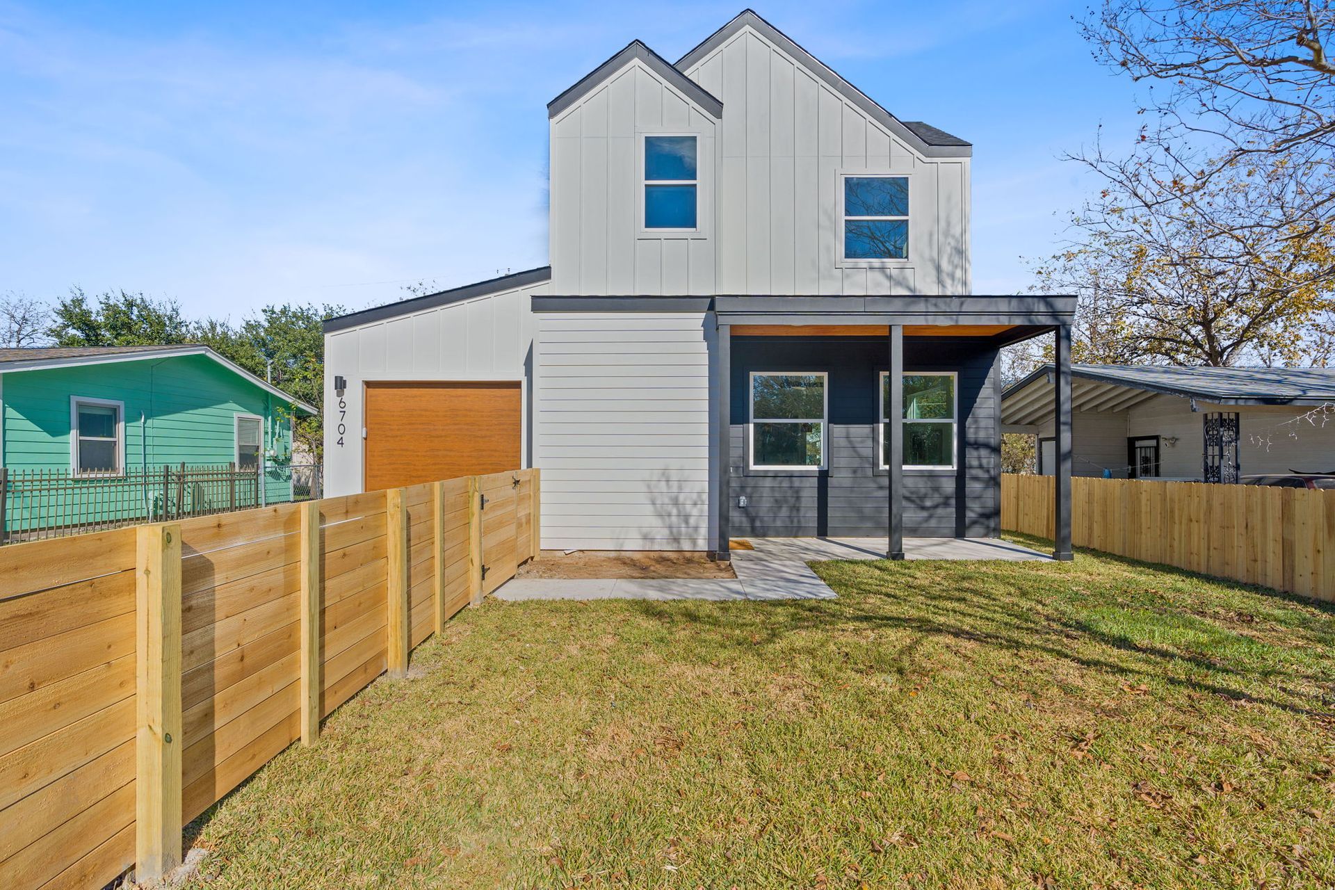 a white house with a wooden fence in front of it .
