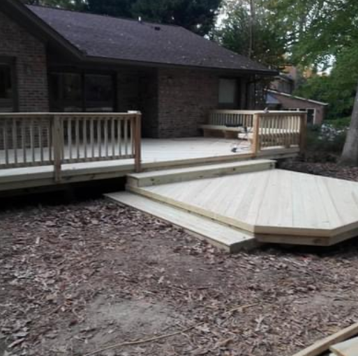A brick house with a wooden deck in front of it