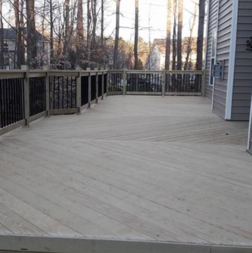 A large wooden deck with a fence around it