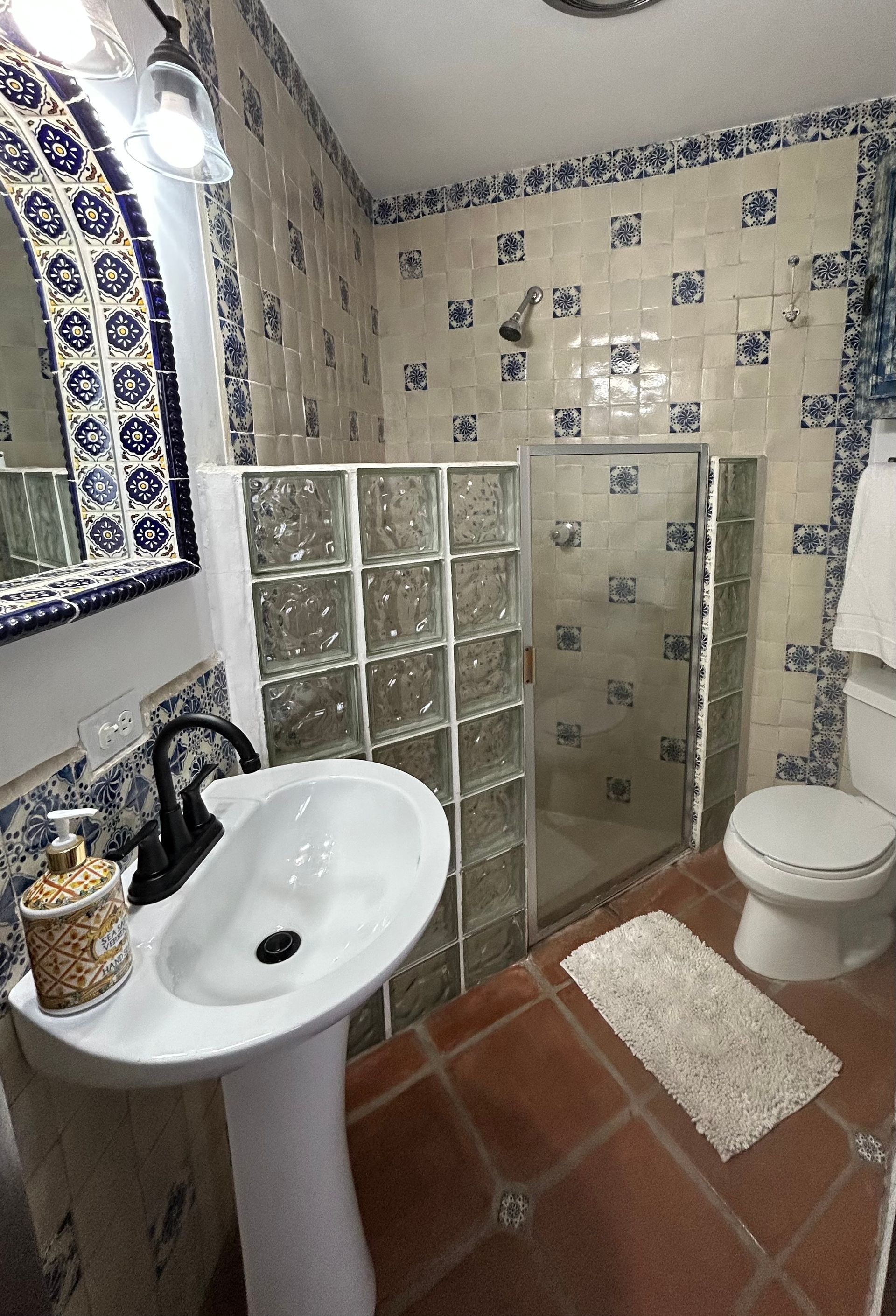 The bathroom with Spanish blue tiles and a shower