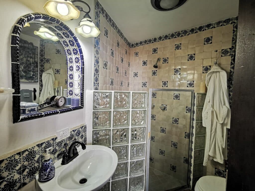The bathroom with Spanish blue tiles and a shower