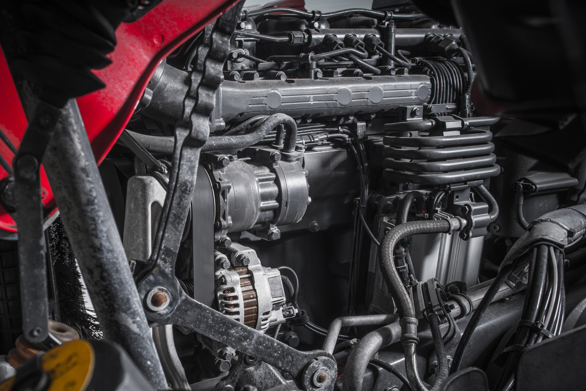 A close up of a motorcycle engine with a lot of wires coming out of it.