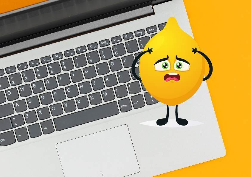 A cartoon lemon looking worried and upset, standing on a laptop