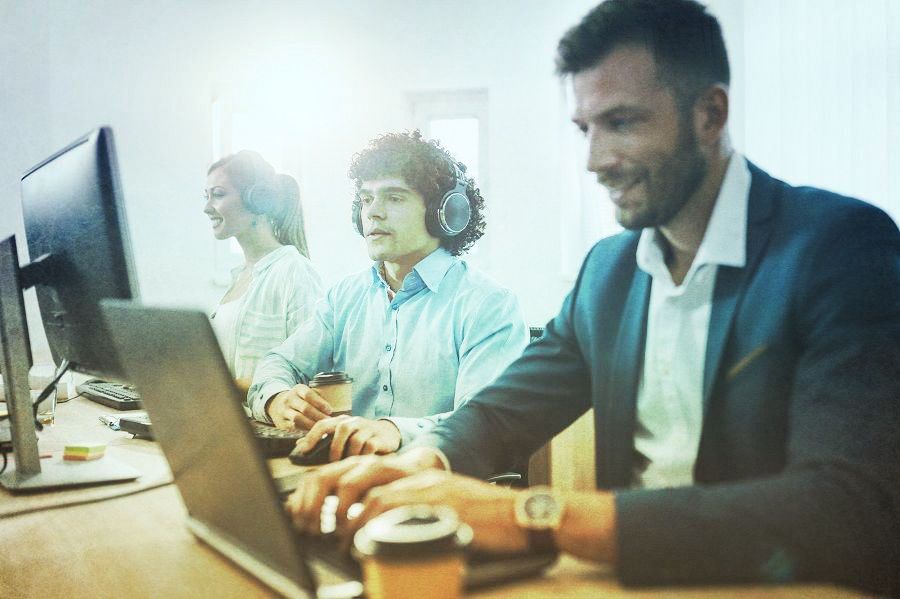 People at work on an IT service desk answering support calls