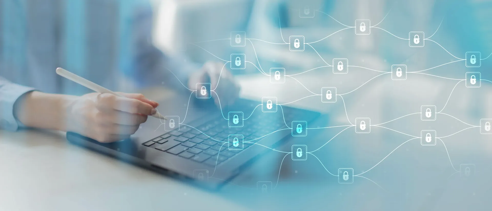 Someone working on a computer keyboard with graphics of padlocks connected