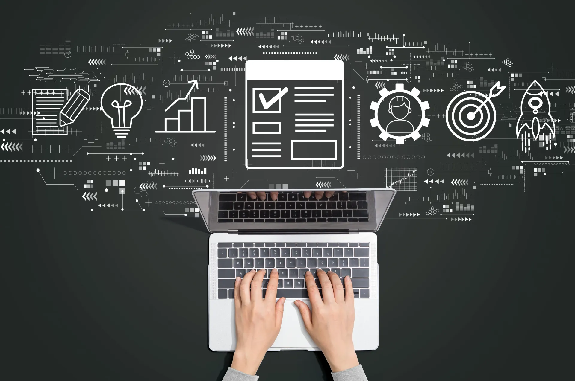 Person working on a laptop with an image background of connected technology and digital symbols and graphics