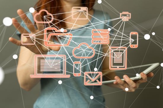IT system icons joined by a network of lines with a woman in the background