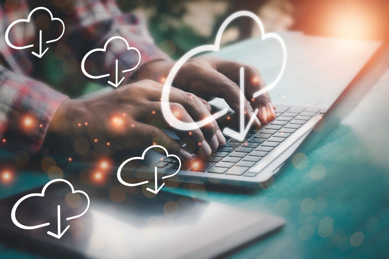 Some typing on a laptop with backup clouds dotted around