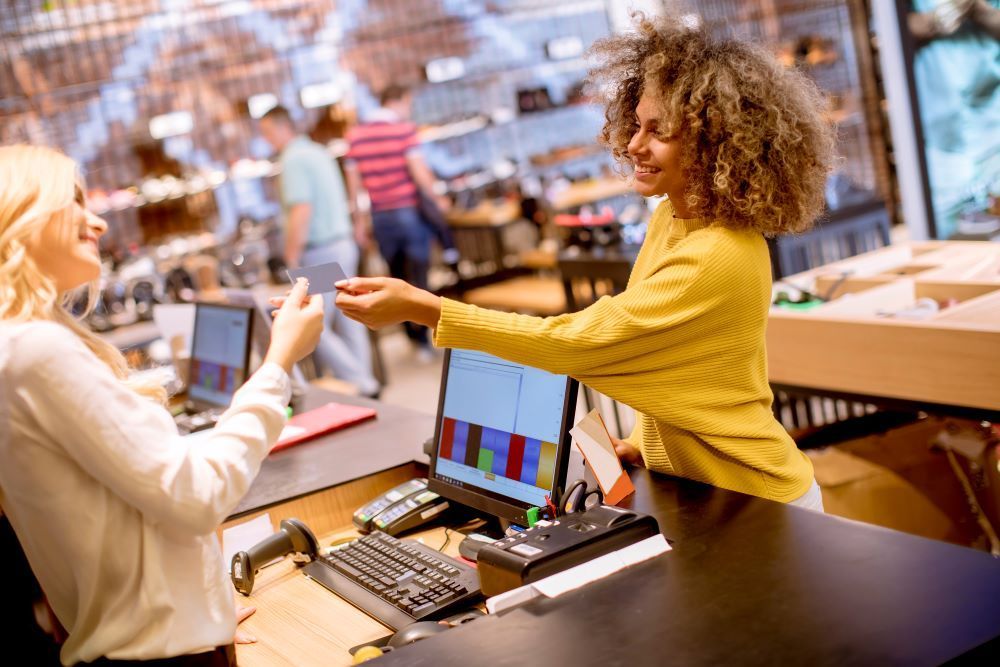 Women paying for her shopping at a retail checkout