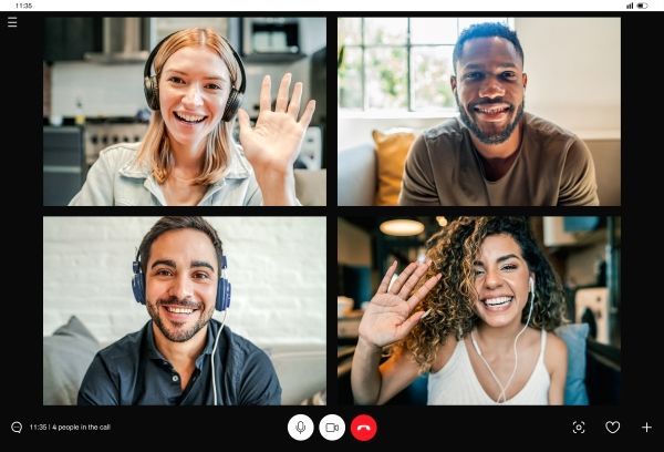 A view of a teams video call between four people, all smiling and a couple of them waving