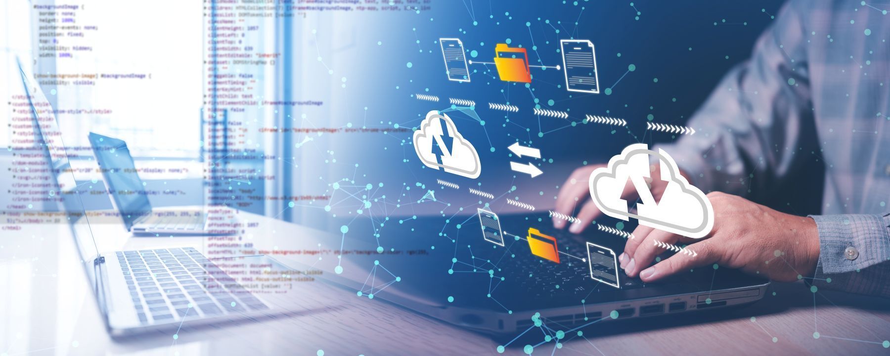 Man typing on a laptop with graphics of computer files and folders held in the cloud