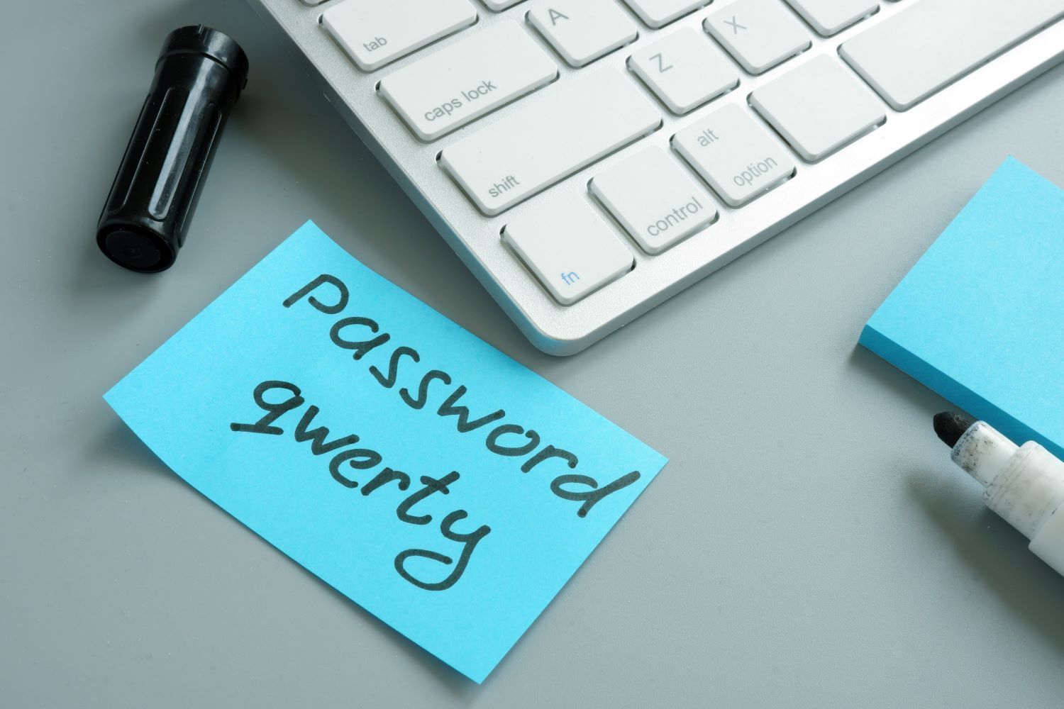 A post it note with 'password qwerty' written on it